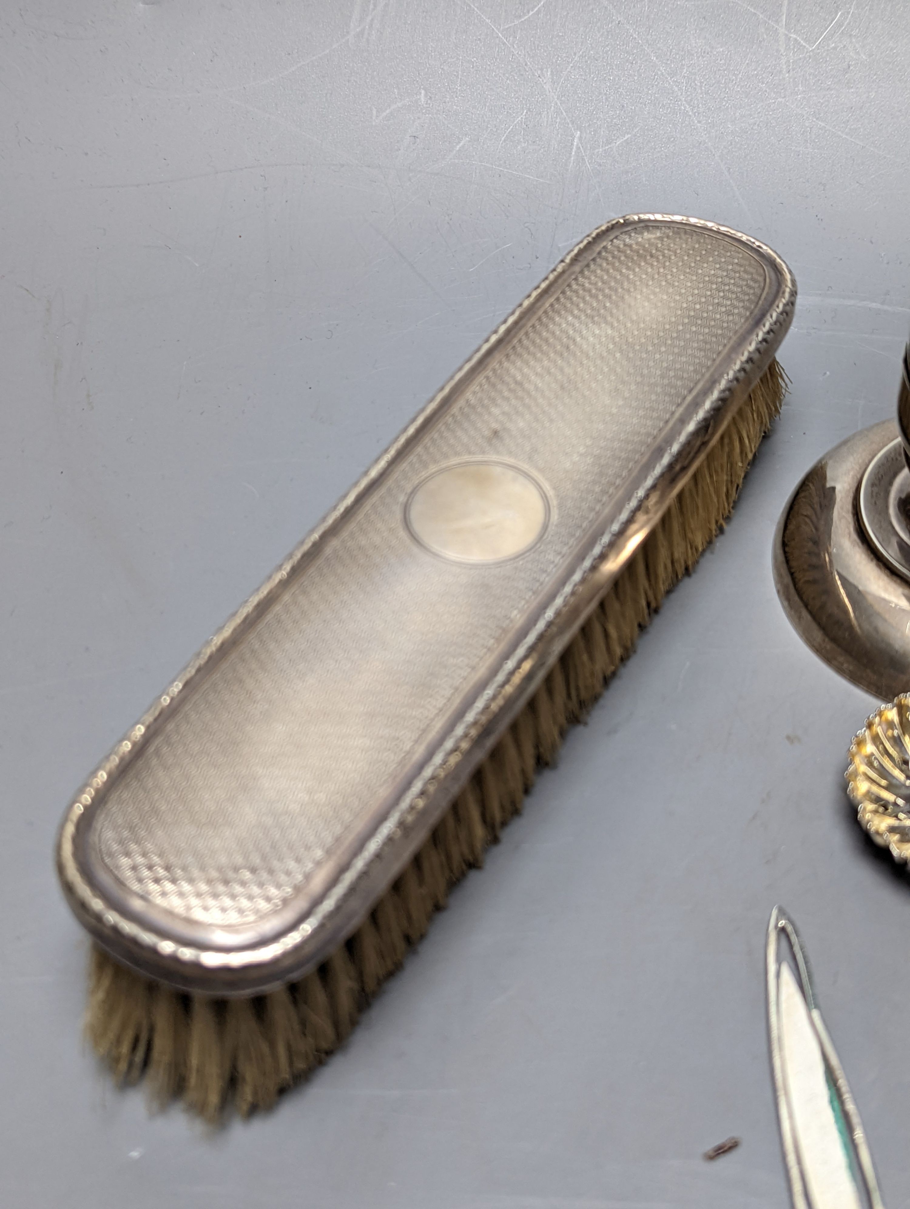 Mixed collectable small silver etc. including silver cream jug, clothes brush, mounted glass posy vase, sugar tongs, owl book mark, spoons and other items.